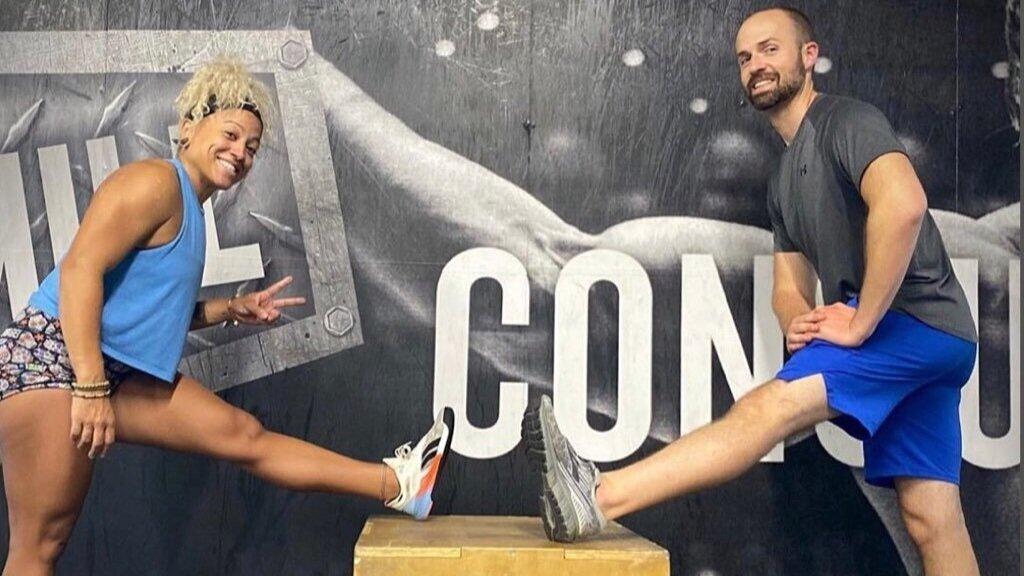 Two people putting their legs on a box